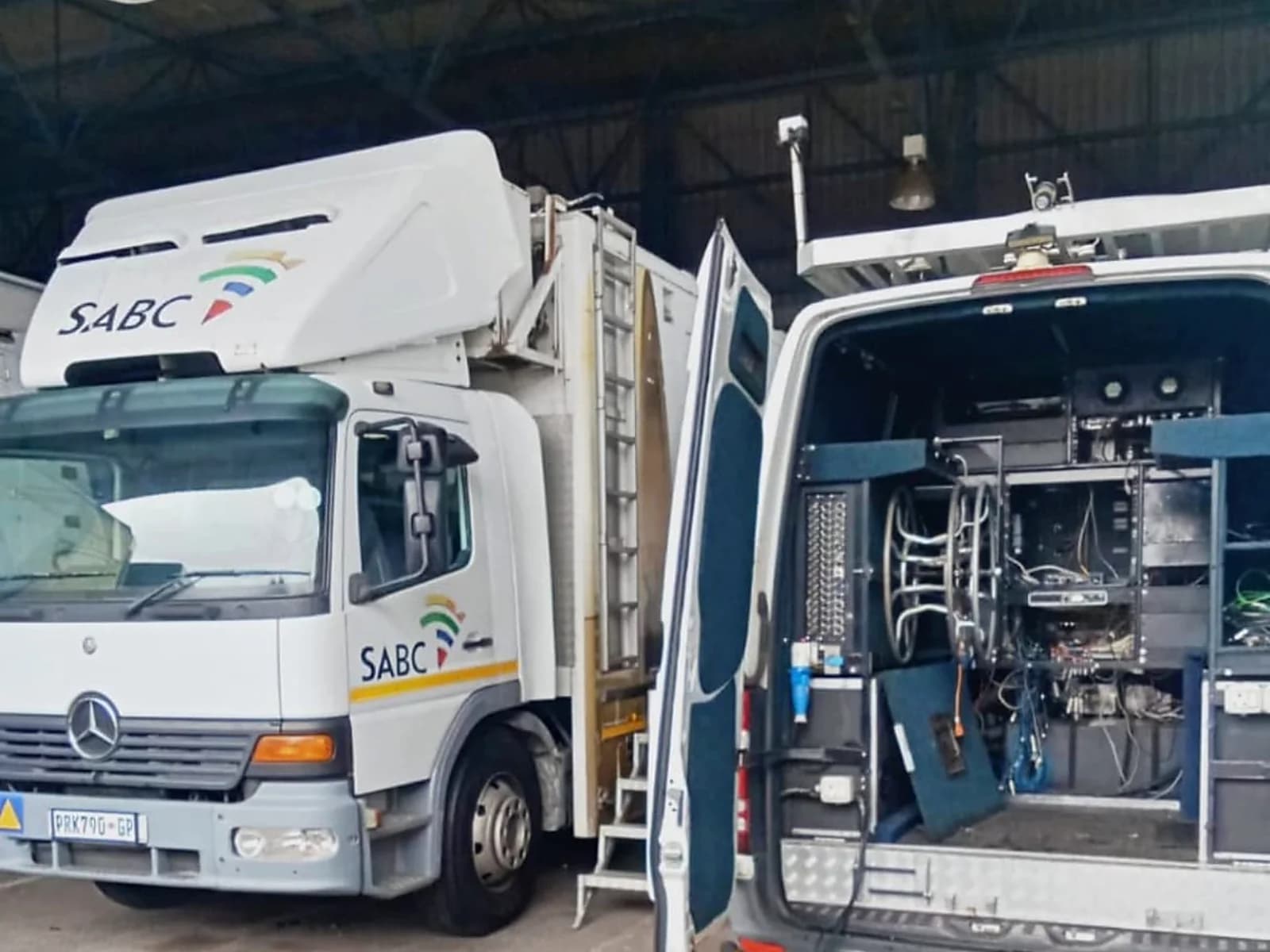 SABC mobile broadcast truck and support vehicle used for backup power and field operations.